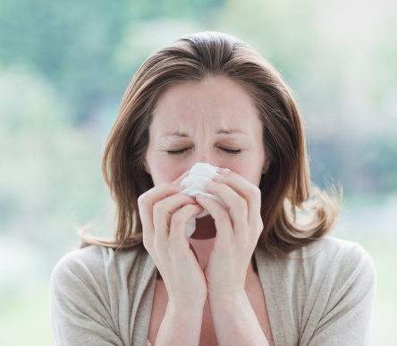 Woman wiping her nose. Use air cleaners against pollen