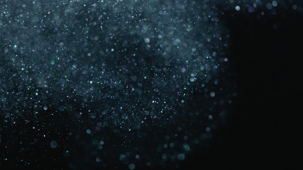 black background with a high amount of white particles floating in the air